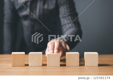 businessman standup choose and wood empty five blocks with copy space for text or symbols, development concept for growth success process. 125381174