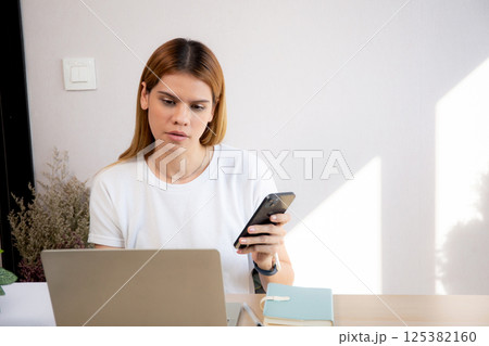 Young caucasian businesswoman texting with serious and concentration with laptop computer. Young caucasian businesswoman texting with serious and concentration with laptop computer. 125382160