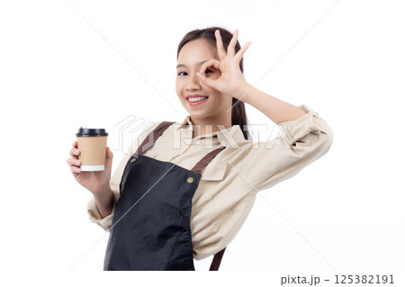 Portrait young asian woman barista holding a takeaway coffee cup with excited gesture ok isolated. Portrait young asian woman barista holding a takeaway coffee cup with excited gesture ok isolated. 125382191