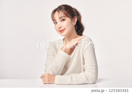 A beautiful young Asian woman with clean, fresh skin against a white background. Skincare, facial treatment, cosmetology, beauty, and spa. An elegant portrait of an Asian woman. A beautiful young Asian woman with clean, fresh skin against a white background. Skincare, facial treatment, cosmetology, beauty, and spa. An elegant portrait of an Asian woman. 125383381