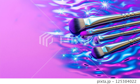 Colorful makeup brushes on iridescent background with sparkling highlights 125384022