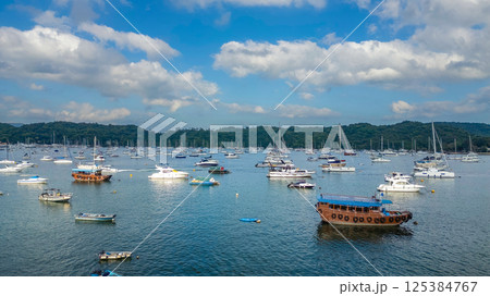 April 21 2025 Scenic Harbor View With Boats Anchored Under a Vibrant Sky 125384767