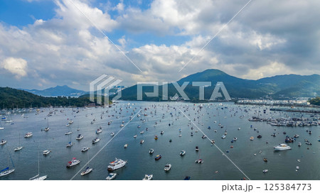 April 21 2025 Scenic Harbor View With Boats Anchored Under a Vibrant Sky 125384773