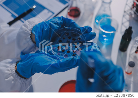 Researcher using a professional microscope Researcher using a professional microscope 125387850