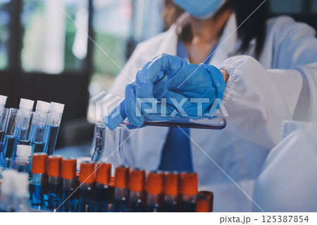 Researcher using a professional microscope Researcher using a professional microscope 125387854