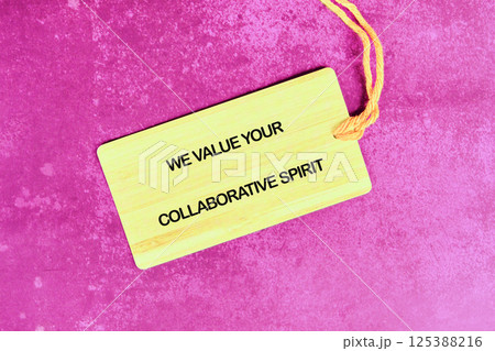 Collaborative spirit emphasized through a wooden tag on a vibrant pink background Collaborative spirit emphasized through a wooden tag on a vibrant pink background 125388216