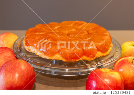 Homemade apple Tarte Tatin with shiny fruit topping and buttery crust Homemade apple Tarte Tatin with shiny fruit topping and buttery crust 125389481