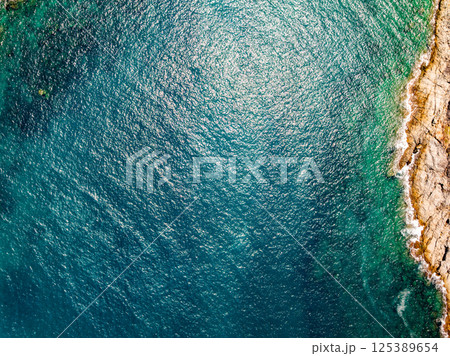 Top view seashore waves nature background,Amazing waves crashing on rocks seascape view 125389654