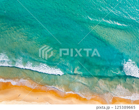 Top view beach waves nature background,Amazing waves crashing on sandy shore seascape view 125389665