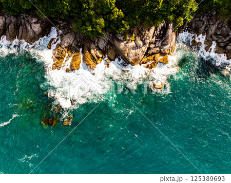 Top view seashore waves nature background,Amazing waves crashing on rocks seascape view 125389693
