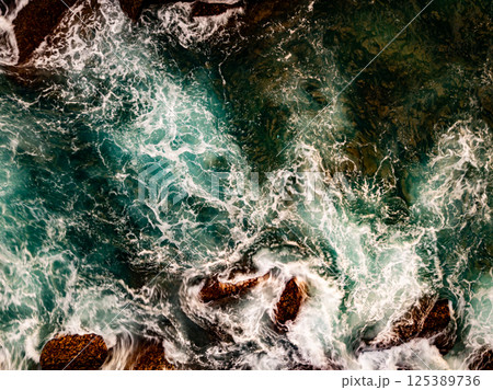 Top view seashore waves nature background,Amazing waves crashing on rocks seascape view 125389736