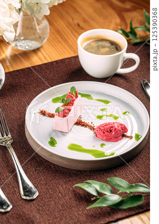 Portion of pink raspberry mousse dessert 125390368