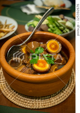Braised eggs with pork belly 125392676