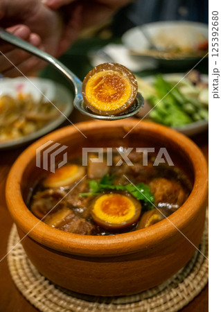 Braised eggs with pork belly 125392680