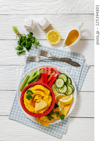 creamy roast carrot hummus in red bowl creamy roast carrot hummus in red bowl 125394801