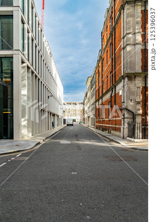 A Quiet Narrow Street in London Blends Modern and Traditional Architecture Under a Partly Cloudy Sky. A Quiet Narrow Street in London Blends Modern and Traditional Architecture Under a Partly Cloudy Sky. 125396037