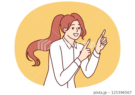 Woman smiles and points finger at copy space, recommending pay attention to interesting promo offer 125396567