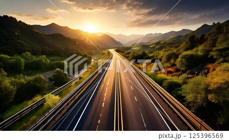 Scenic view of Firefly highway at sunset with mountain backdrop and winding road 125396569