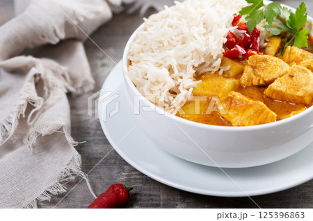 Massaman curry in bowl on wooden table. Traditional Thai food recipe. 125396863