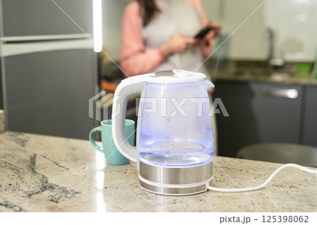 Modern glass electric kettle with boiling water. Modern glass electric kettle with boiling water. 125398062