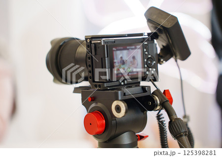 A professional black camera for taking photos and videos at the holiday. A professional black camera for taking photos and videos at the holiday. 125398281