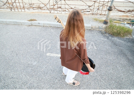 Girl Plays The Bass Instrument Music In The Street 125398296