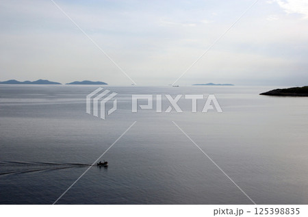 Fishermans in boat sailing out Fishermans in boat sailing out 125398835