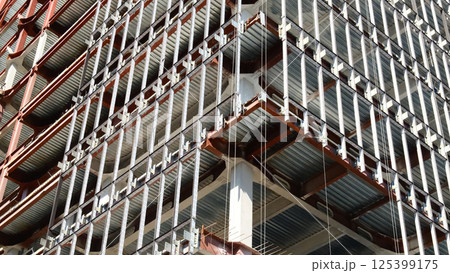 Construction site showing modern building framework with exposed steel beams Construction site showing modern building framework with exposed steel beams 125399175