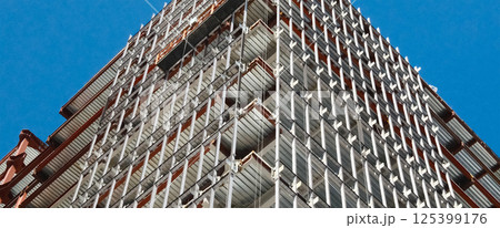 Construction site showing modern building framework with exposed steel beams Construction site showing modern building framework with exposed steel beams 125399176