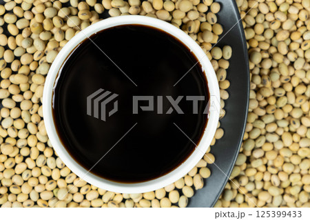 Soy Sauce in Dipping Bowl with Soybeans Around 125399433