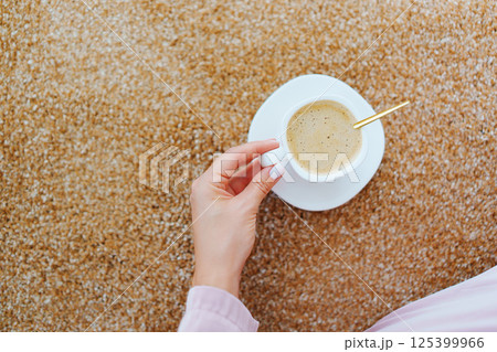 close-up. a cup of coffee on the beige Interior pile carpet. 125399966