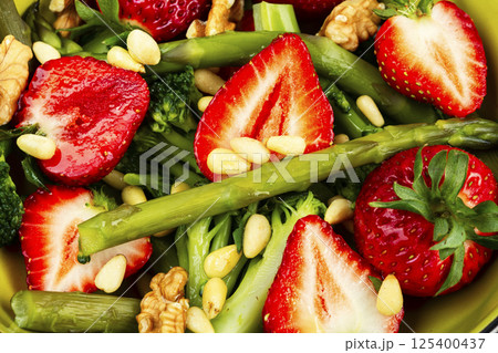 Green mixed salad with green asparagus and strawberries. Green mixed salad with green asparagus and strawberries. 125400437
