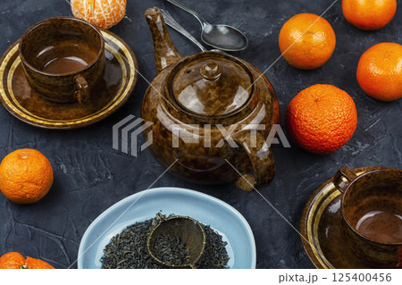 Mandarin tea in glass teapot or kettle. Mandarin tea in glass teapot or kettle. 125400456