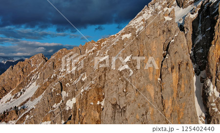 Rocky snow mountains at sunset aerial Rocky snow mountains at sunset aerial 125402440