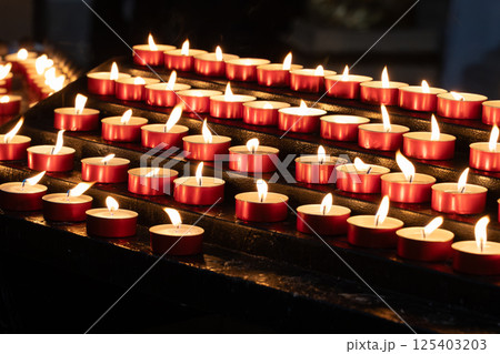 Rows of Red Tealight Candles Burning 125403203
