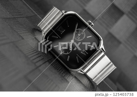 Wristwatch on a dark reflective background. Wristwatch on a dark reflective background. 125403738
