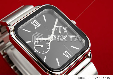 Closeup product shot of a precious silver metal chronograph wrist watch with a black design placed 125403740