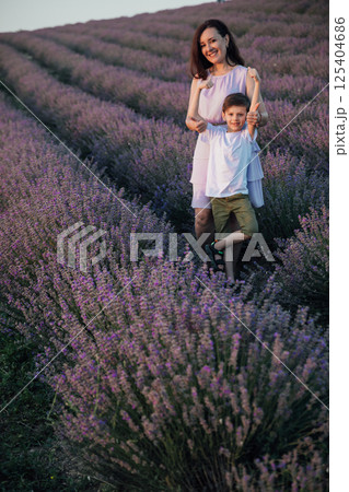 Mom and son smiling in summer on a field of lavender 125404686