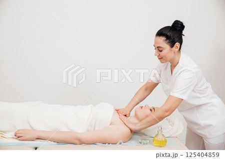 Doctor Giving Woman Relaxing Massage In Spa Doctor Giving Woman Relaxing Massage In Spa 125404859