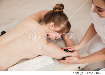 Doctor Giving Woman Relaxing Massage In Spa Doctor Giving Woman Relaxing Massage In Spa 125404860
