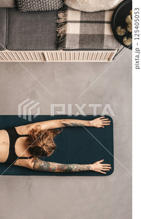 Woman Practicing Yoga and Doing Stretching Exercises 125405053