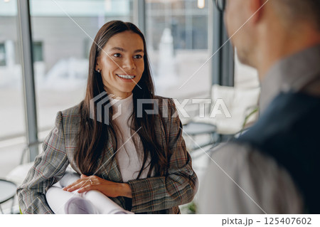 A Business Meeting Featuring Engaging and ThoughtProvoking Discussion in a Modern Office 125407602