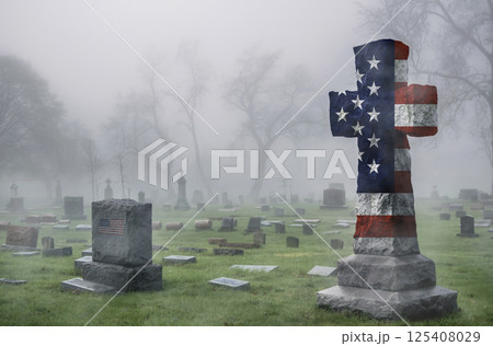 American flag cross monument in cemetery on foggy day, symbol of patriotism, faith, and remembrance 125408029