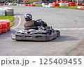 Exciting go-karting adventure on a thrilling racing track during bright afternoon 125409455