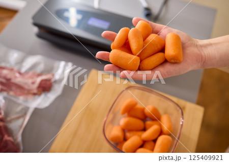 Preparing Healthy Meals Focus on Carrots and the Benefits of Vacuum Sealing Techniques 125409921