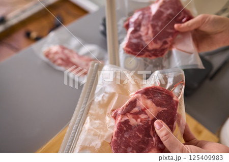 Sealing Fresh Meat for Preservation Using a Vacuum Sealer for Longer Lasting Freshness 125409983
