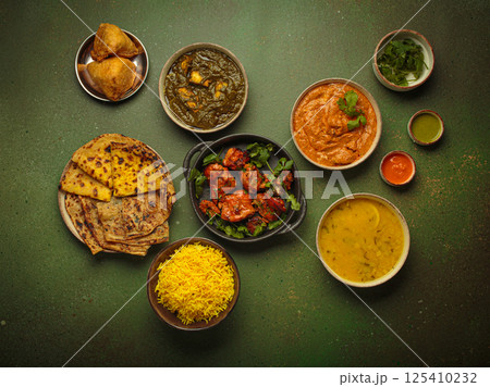 Traditional Indian dishes top view on green background table. Cuisine of India Traditional Indian dishes top view on green background table. Cuisine of India 125410232