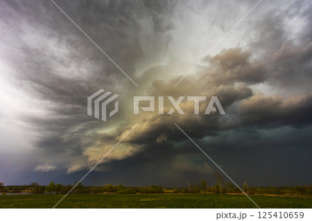 Dramatic storm clouds in the sky, dark severe storm clouds, supercell. 125410659