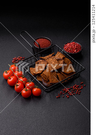 Crispy homemade brown bread chips with seeds and grains, salt, spices 125411214