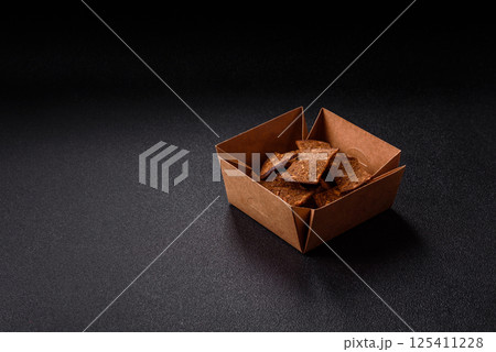 Crispy homemade brown bread chips with seeds and grains, salt, spices Crispy homemade brown bread chips with seeds and grains, salt, spices 125411228